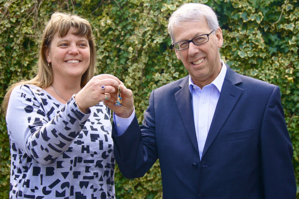 Karen Wroe, Project Director, receiving keys to their new home from Neil Myerson of Neil Myerson Solicitors